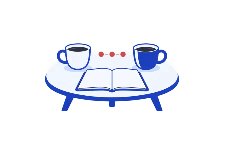 An open notebook between two cups on a round table
