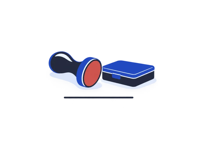 A rubber stamp lying beside a closed ink pad